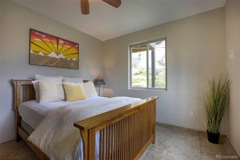 a bedroom with a bed and a painting on the wall