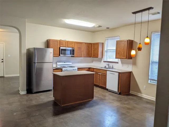a kitchen with a refrigerator and a sink