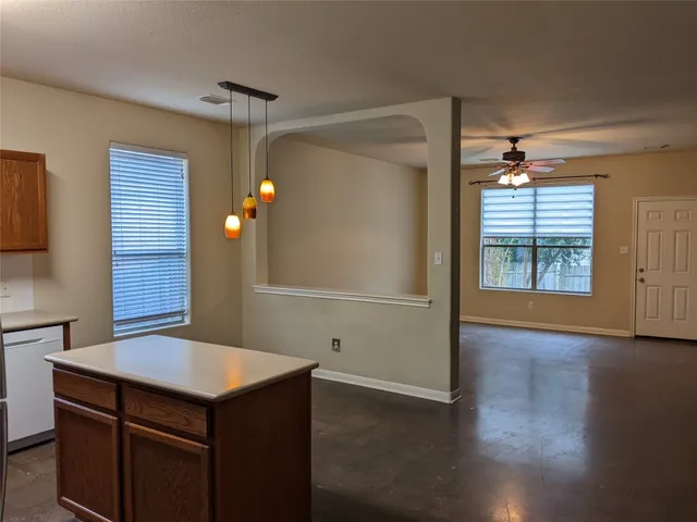 a view of kitchen with a sink and a refrigerator