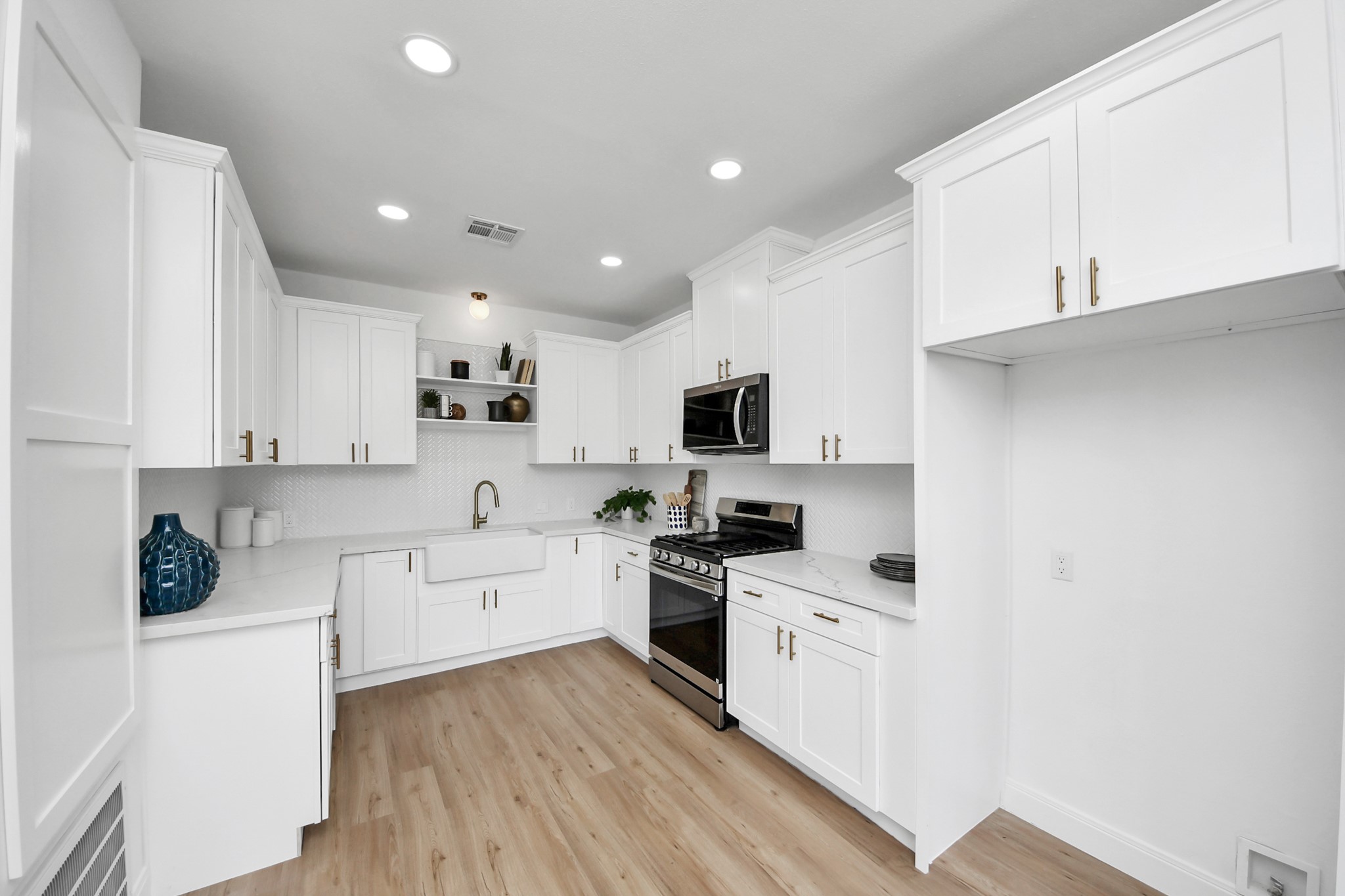 300 Narcissus Road Kemah, TX 77565 - Photo 20 of 47 a kitchen with white cabinets and white appliances