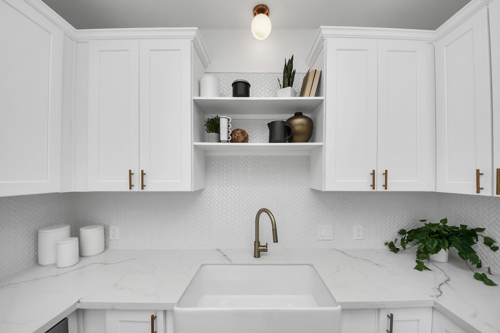 300 Narcissus Road Kemah, TX 77565 - Photo 26 of 47 a kitchen with a sink a refrigerator and cabinets