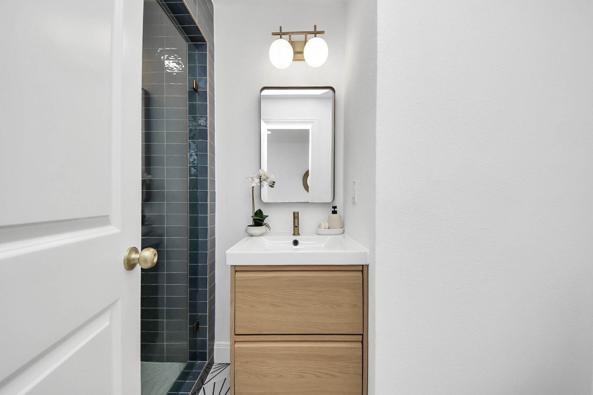 300 Narcissus Road Kemah, TX 77565 - Photo 7 of 47 a bathroom with a sink a mirror and vanity