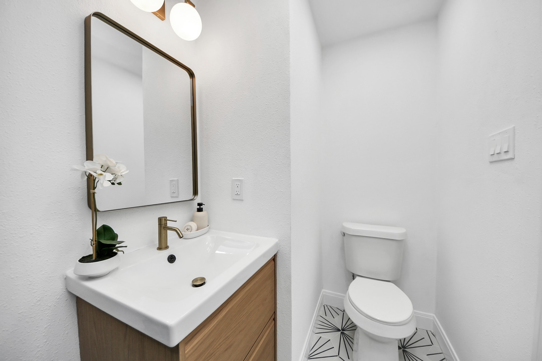 300 Narcissus Road Kemah, TX 77565 - Photo 8 of 47 a bathroom with a sink mirror and toilet