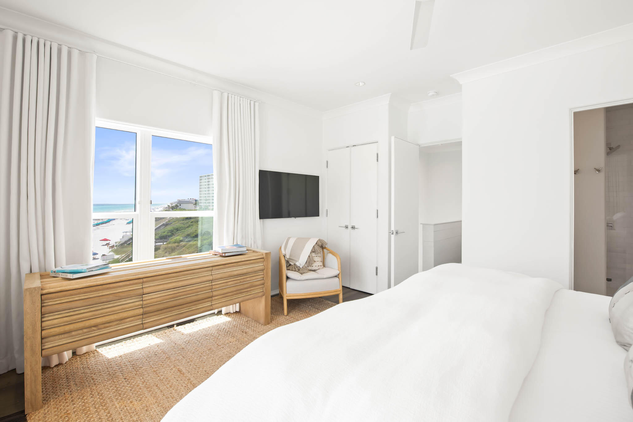 49 Hinton Drive, Unit 5 Santa Rosa Beach, FL 32459 - Photo 30 of 58 a bedroom with a bed and a flat tv screen next to a window