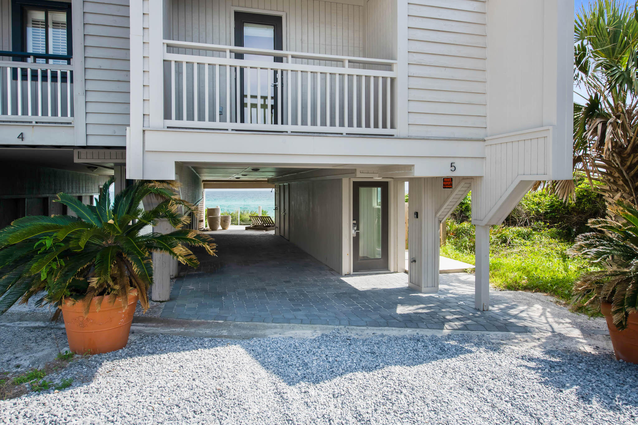 49 Hinton Drive, Unit 5 Santa Rosa Beach, FL 32459 - Photo 51 of 58 a view of a house that has a potted plants and a table chair