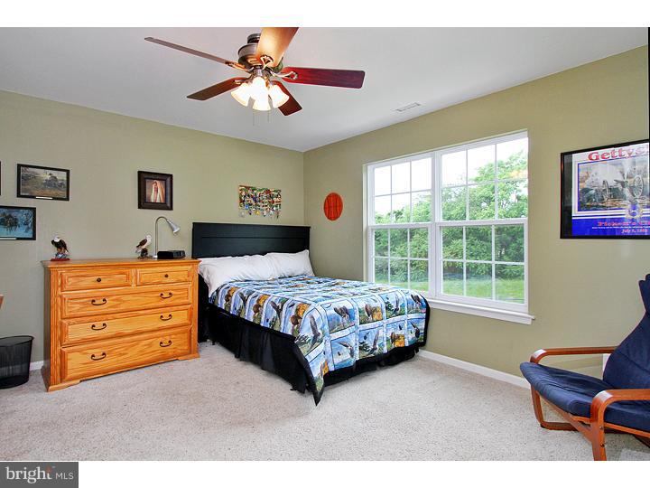 160 Prairie View Lane Mickleton, NJ 08056 - Photo 18 of 20 a bedroom with a bed a chair and a large window