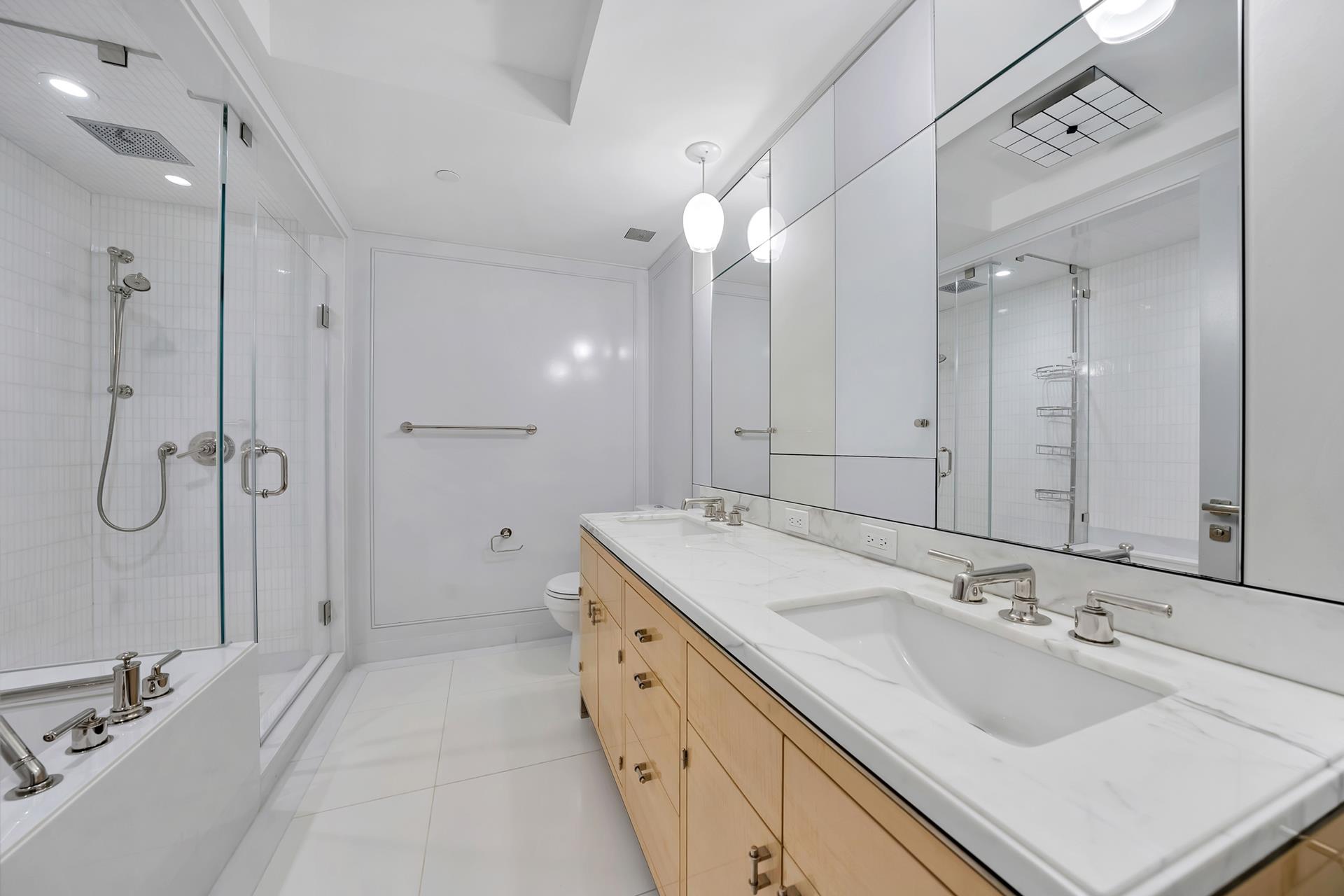 21 East 61st Street, Unit 9D Manhattan, NY 10065 - Photo 5 of 14 a spacious bathroom with a double vanity sink mirror and double