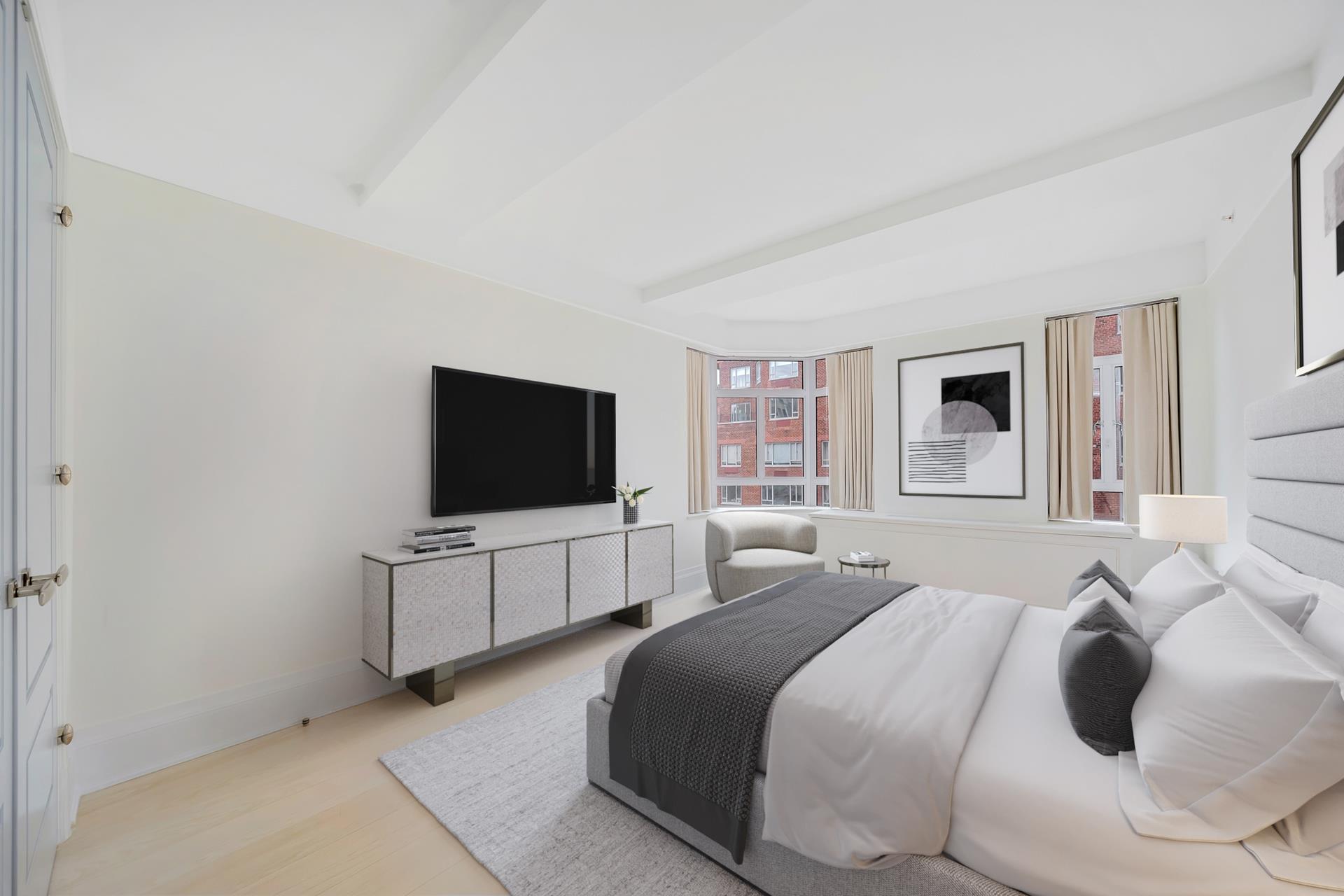 21 East 61st Street, Unit 9D Manhattan, NY 10065 - Photo 6 of 14 a bedroom with a bed and a flat screen tv