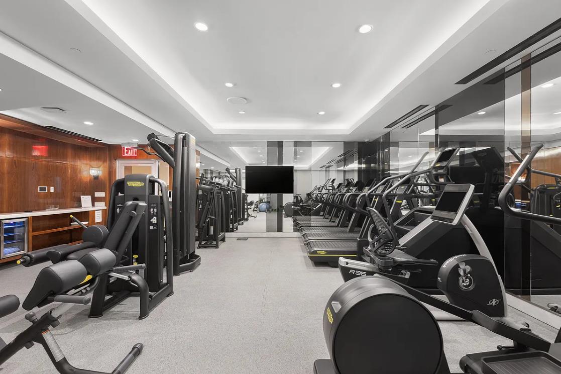 21 East 61st Street, Unit 9D Manhattan, NY 10065 - Photo 8 of 14 a view of a room with gym equipment