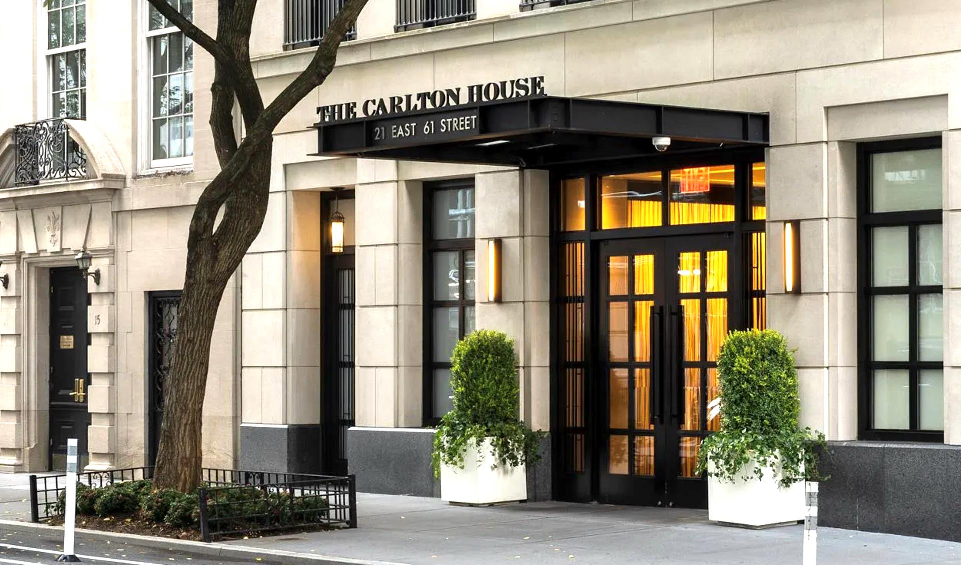 21 East 61st Street, Unit 9D Manhattan, NY 10065 - Photo 9 of 14 a front view of a building with a garden