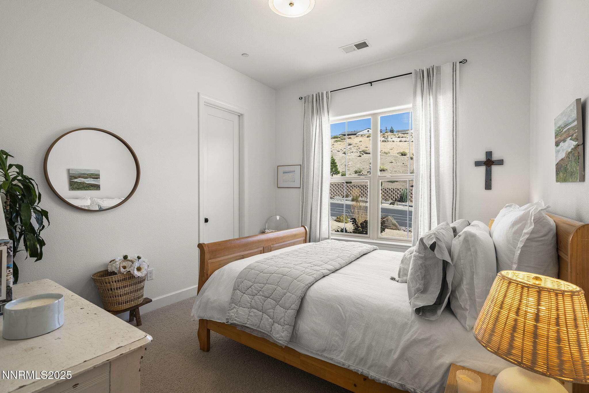 480 Gooseberry Drive Reno, NV 89523 - Photo 27 of 48 a bedroom with bed and a large mirror next to a window