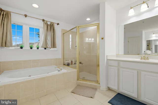 a spacious bathroom with a bathtub shower and a shower