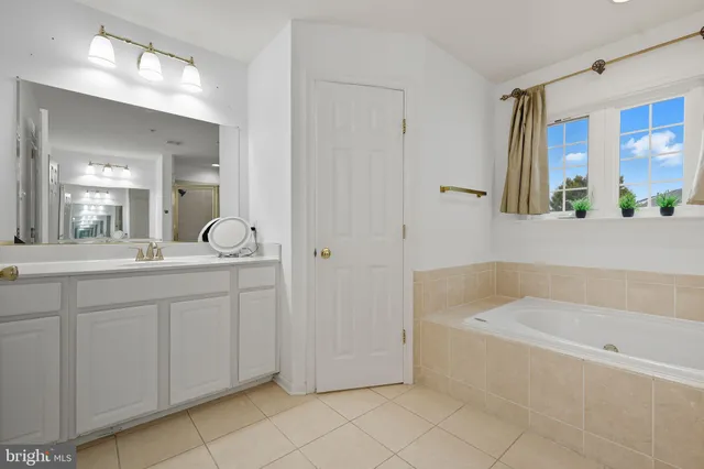 a bedroom with a bed dresser and a window