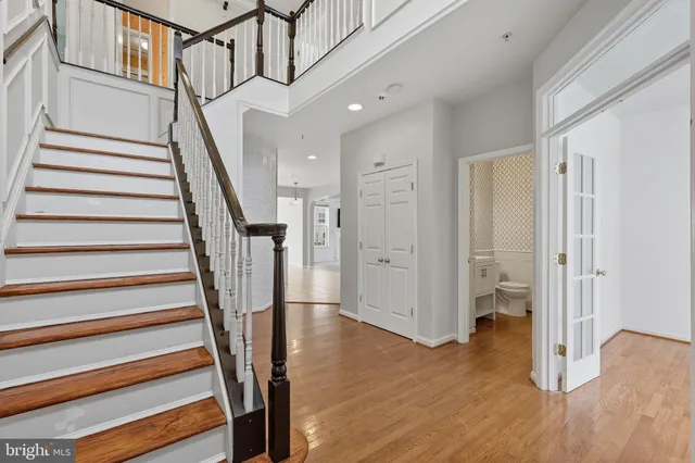 a view of entryway with wooden floor and stairs
