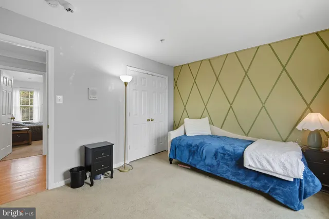 a bedroom with a bed and a desk