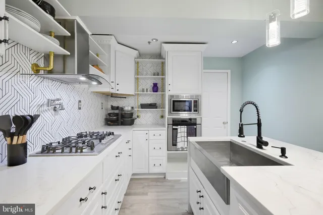a kitchen with a refrigerator a sink and cabinets