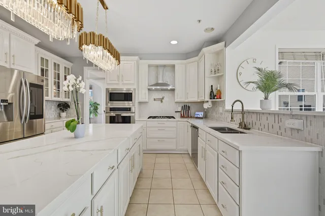 a kitchen with stainless steel appliances kitchen island granite countertop a sink and cabinets