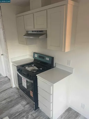 a kitchen with granite countertop a stove and a sink