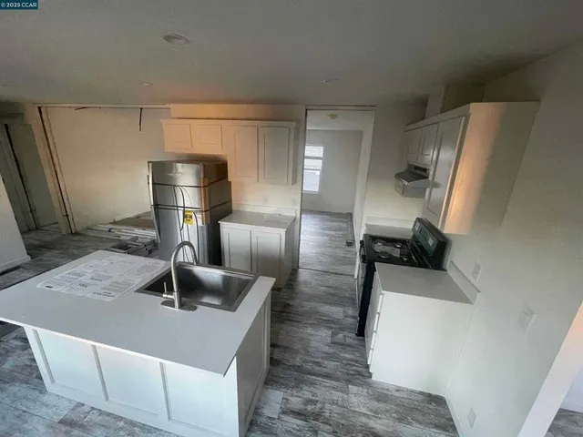 a kitchen with a sink a refrigerator and washer