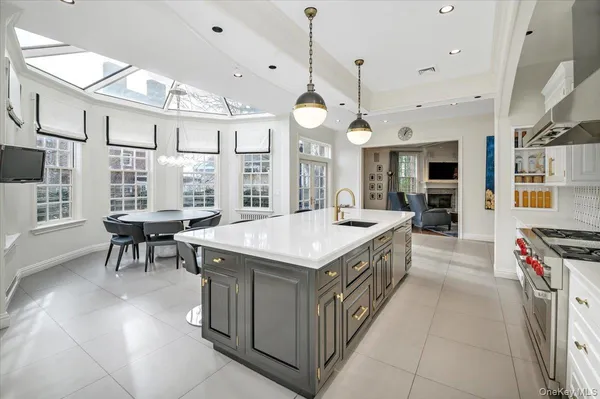 a kitchen with stainless steel appliances granite countertop a stove and a large window