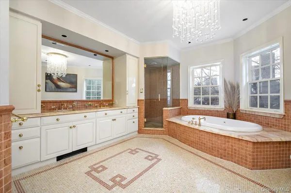 a spacious bathroom with a double vanity sink and a bathtub next to a window