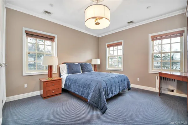 a spacious bedroom with a bed and a window