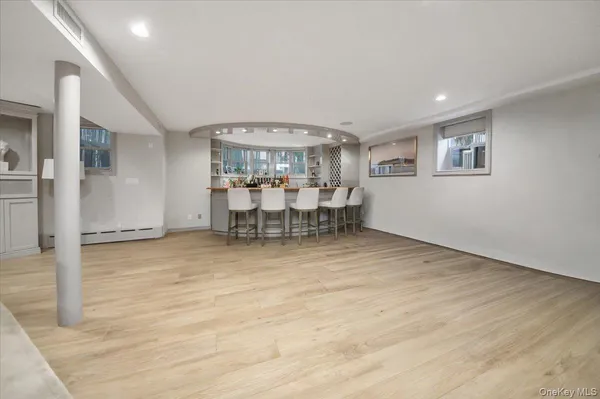 a view of a room with wooden floor wooden table and chairs