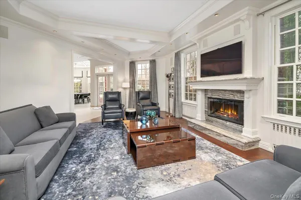 a living room with furniture a flat screen tv and a fireplace