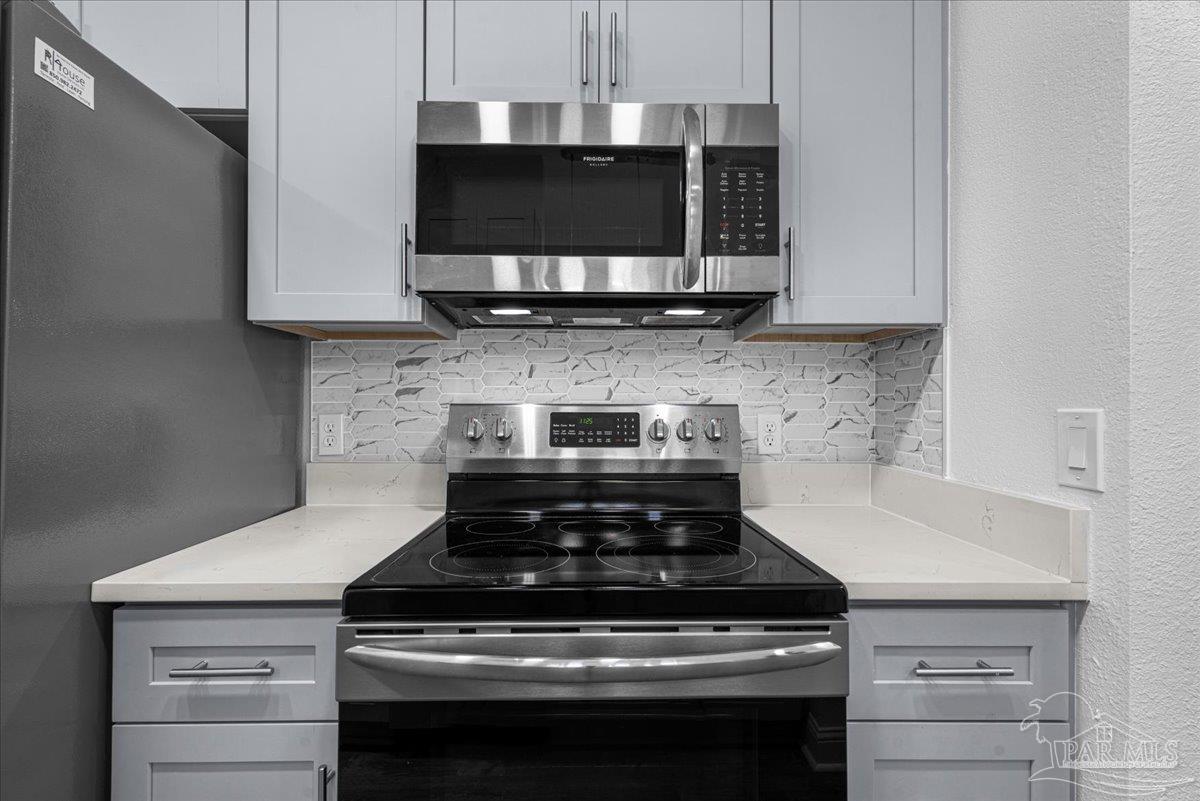 601 East Burgess Road, Unit C3 Pensacola, FL 32504 - Photo 13 of 35 a stove top oven sitting inside of a kitchen