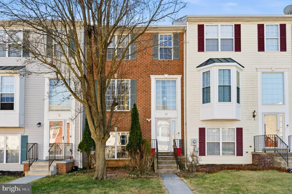 a front view of a residential apartment building with a yard