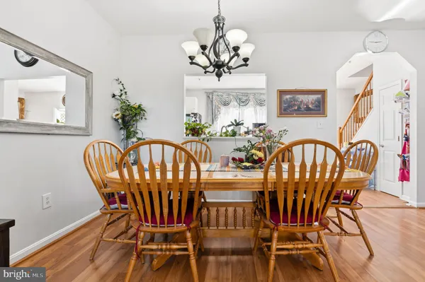 a view of a dining room with furniture wooden floor and chandelier