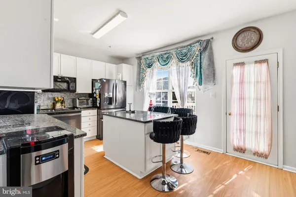 a kitchen with stainless steel appliances a stove a refrigerator and a stove top oven