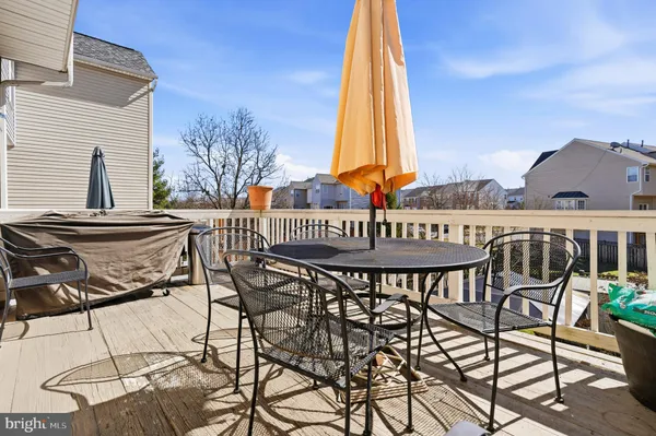 a view of a patio with a table and chairs and potted plants