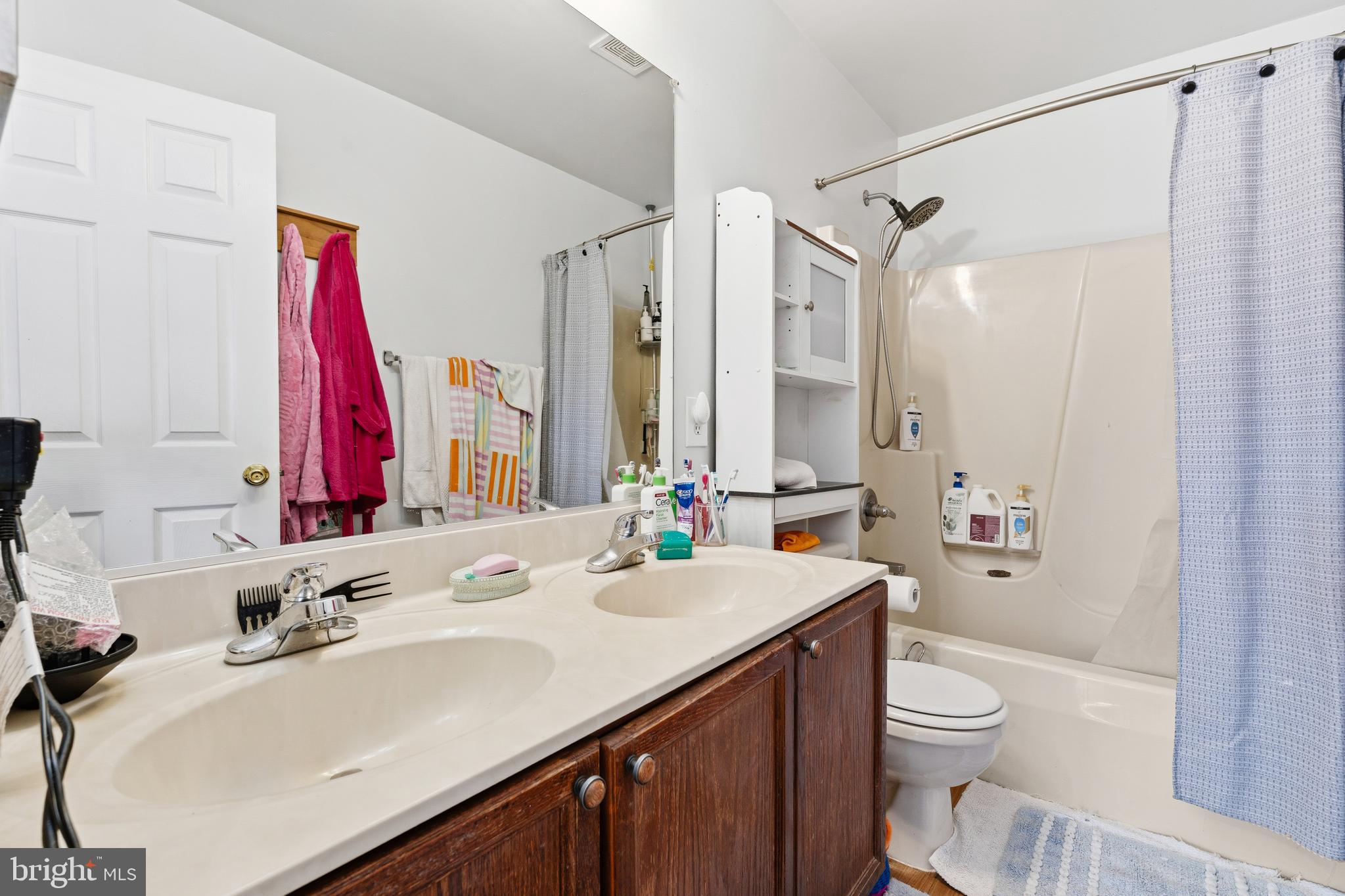 137 Harpers Way Frederick, MD 21702 - Photo 20 of 28 a bathroom with a sink a toilet and a large mirror