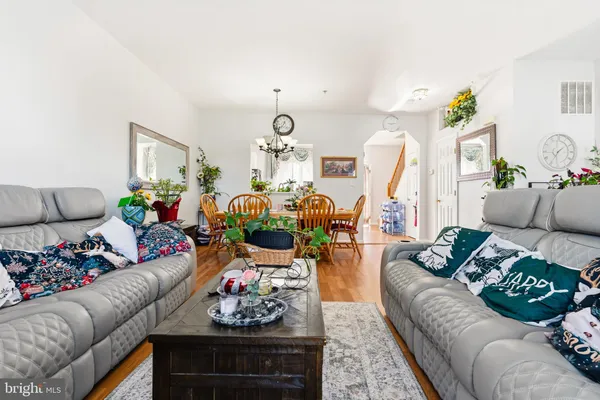 a living room with furniture and flowers