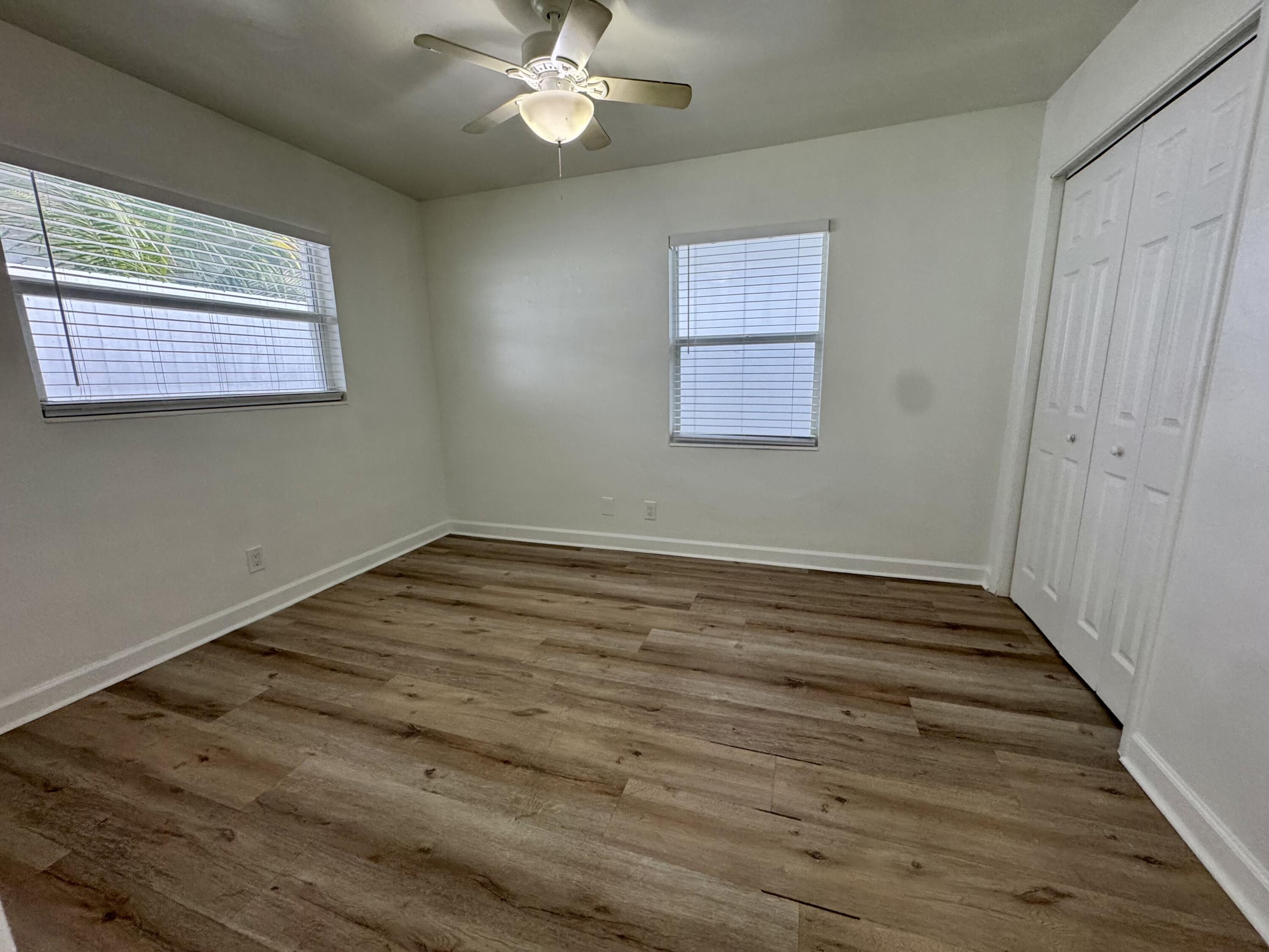 1235 Beach Road, Unit 2 Singer Island, FL 33404 - Photo 12 of 12 a view of a room with wooden floor and fan