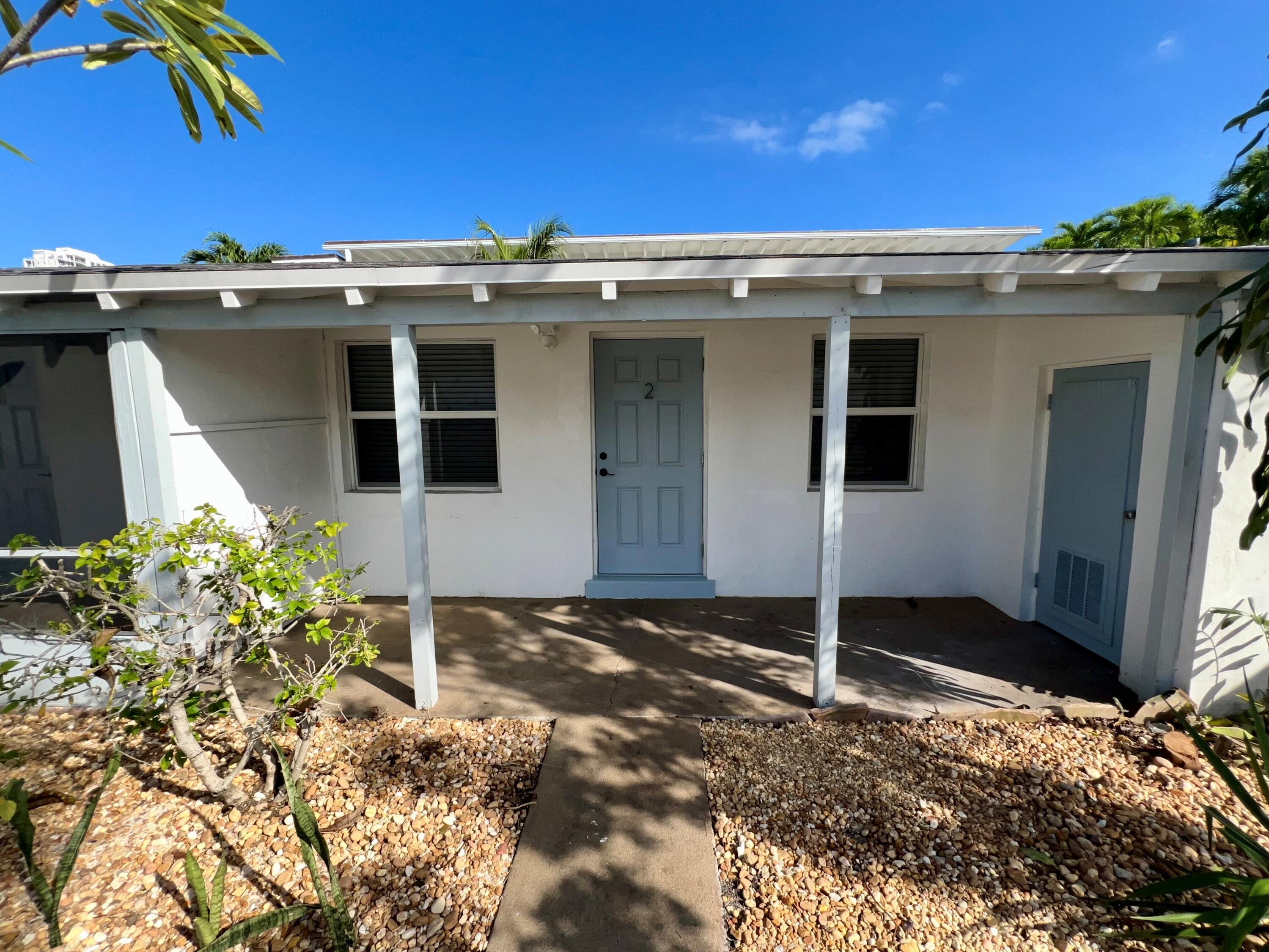 1235 Beach Road, Unit 2 Singer Island, FL 33404 - Photo 5 of 12 a view of a house with a backyard