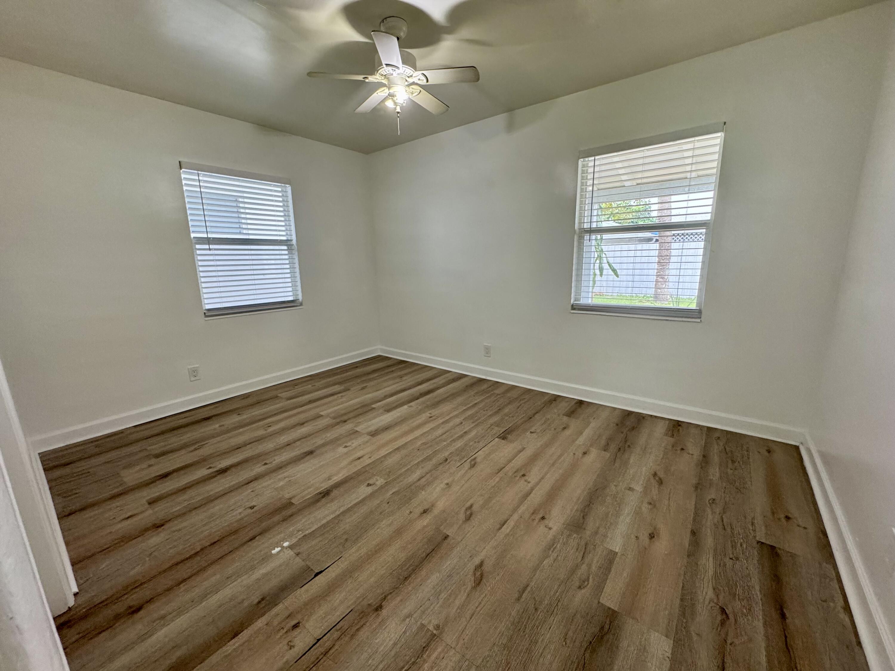 1235 Beach Road, Unit 2 Singer Island, FL 33404 - Photo 10 of 12 wooden floor in an empty room with a window