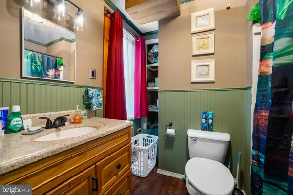 a bathroom with a toilet a sink and a mirror