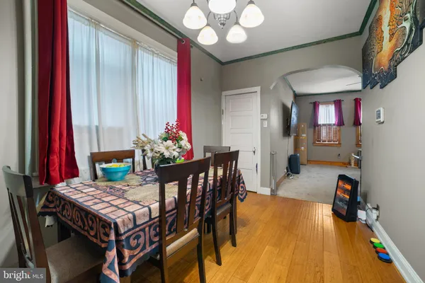 a view of a dining room with furniture and a chandelier