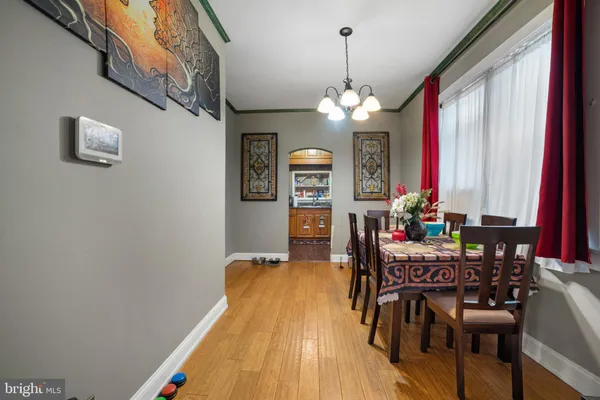 a view of a dining room with furniture and chandelier