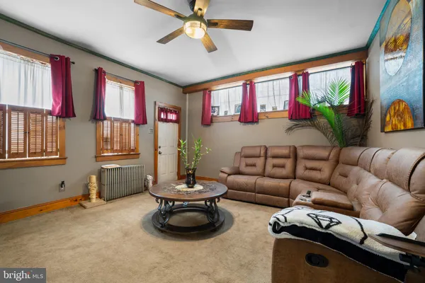 a living room with furniture fireplace and a large window