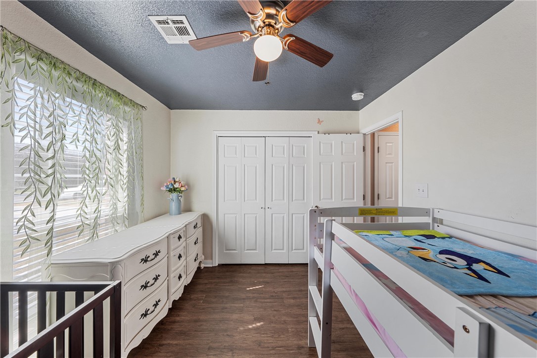 1206 Spring Street Waco, TX 76704 - Photo 18 of 33 a room with furniture a chandelier fan and a window
