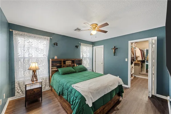 a bedroom with a bed and a chandelier