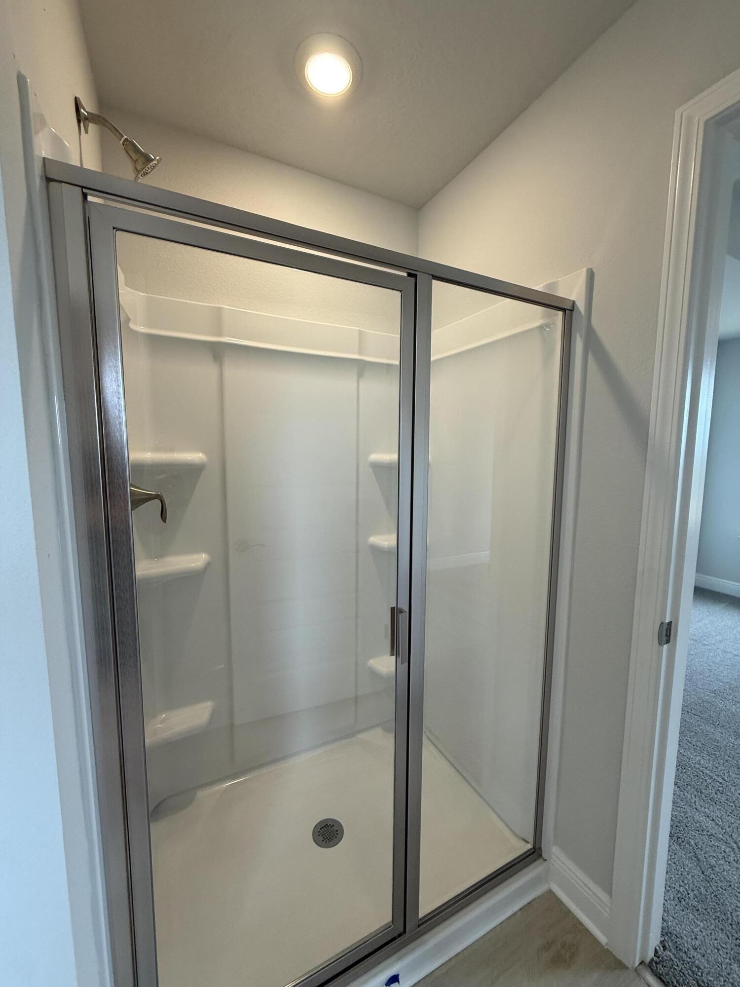 6002 Crocket Cove Crestview, FL 32539 - Photo 22 of 29 a bathroom with a glass shower door