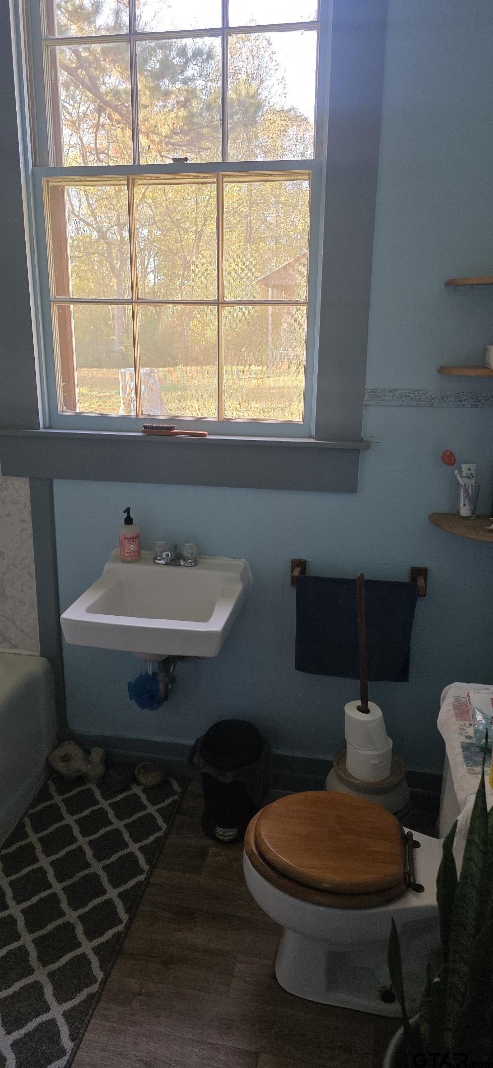 632 Highway 7 Pollok, TX 75969 - Photo 13 of 27 a bathroom with a toilet a sink and a window