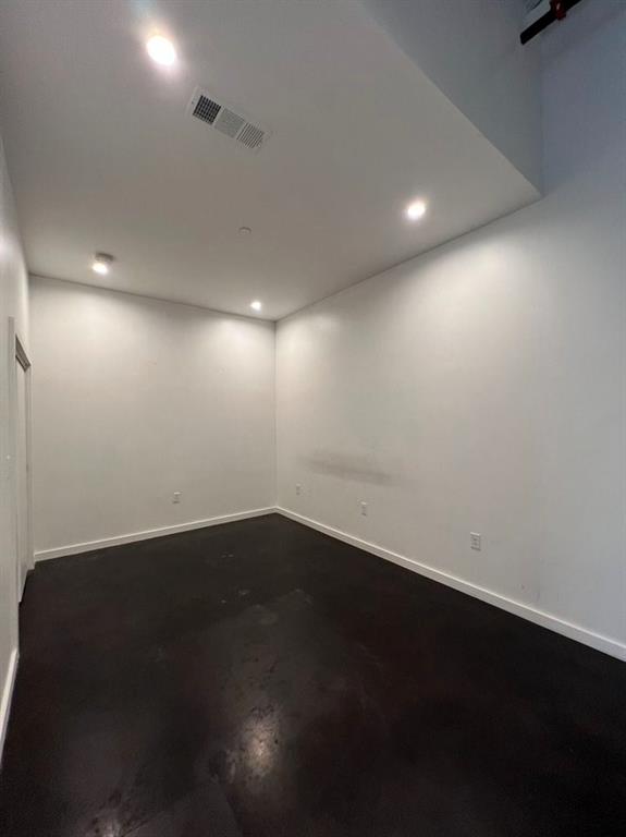 3012 Clover Street, Unit 101 Dallas, TX 75226 - Photo 11 of 15 an empty room with wooden floor and windows