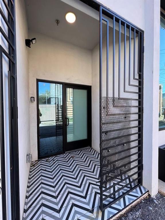 3012 Clover Street, Unit 101 Dallas, TX 75226 - Photo 14 of 15 a view of a hallway with wooden floor and windows