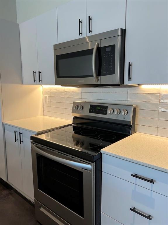 3012 Clover Street, Unit 101 Dallas, TX 75226 - Photo 5 of 15 a kitchen with microwave cabinets and stove top oven