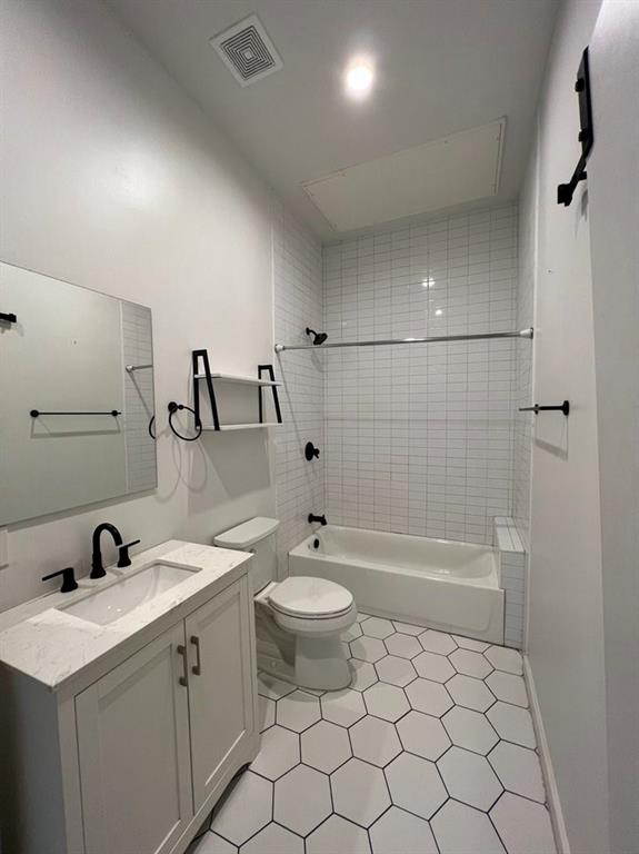 3012 Clover Street, Unit 101 Dallas, TX 75226 - Photo 10 of 15 a bathroom with a double vanity sink toilet and shower